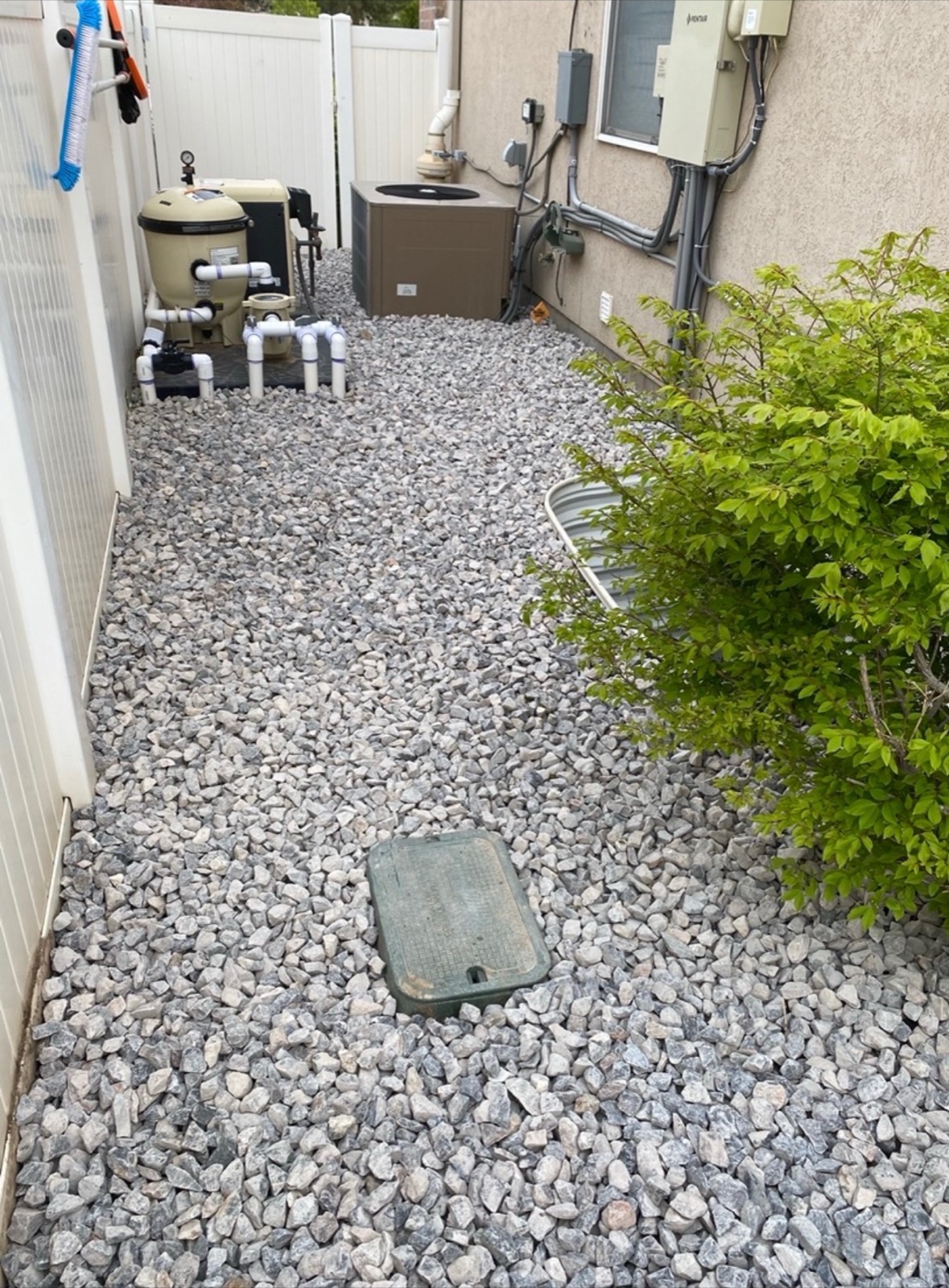 Decorative gravel installed along the side of a house